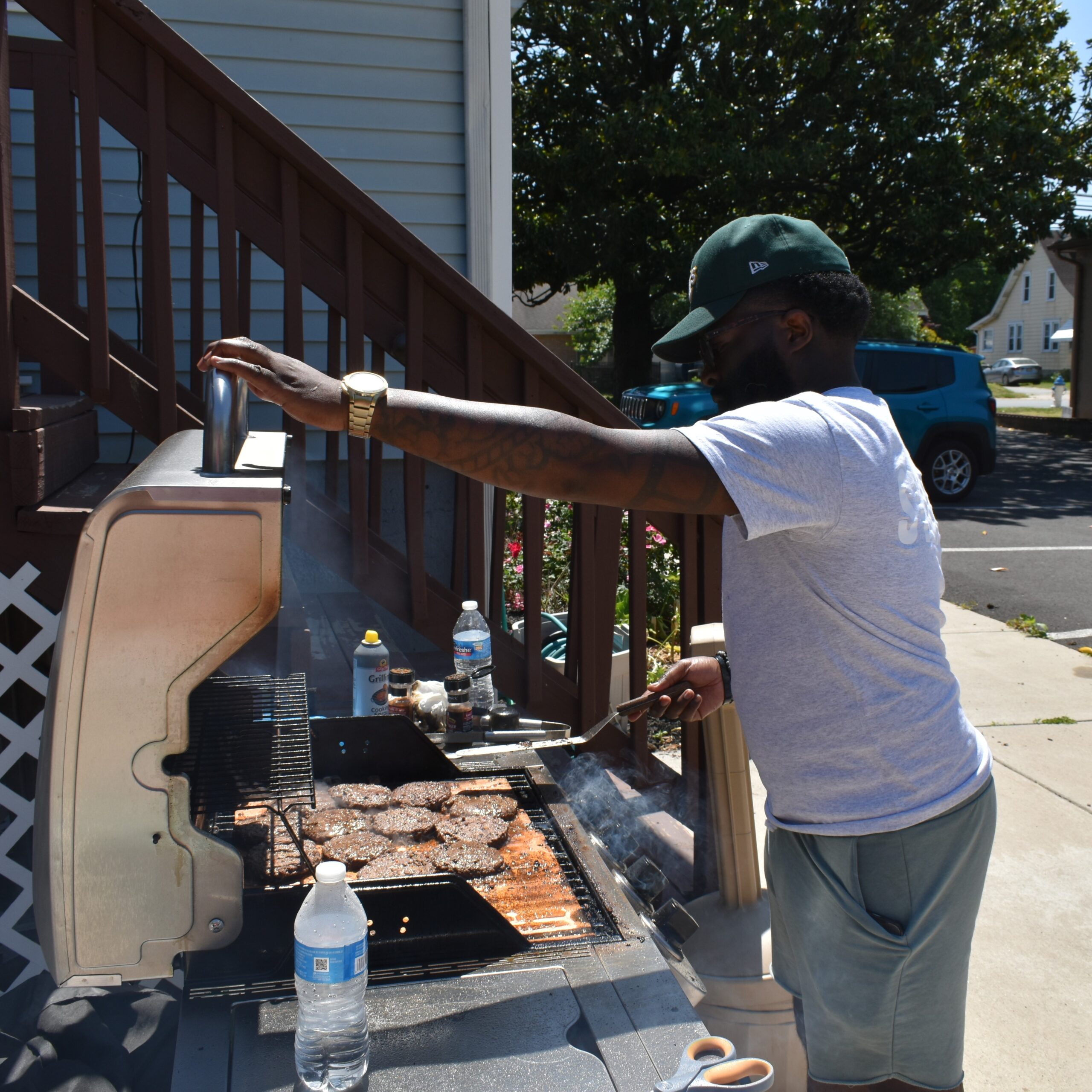 a volunteer grilling burgers outside